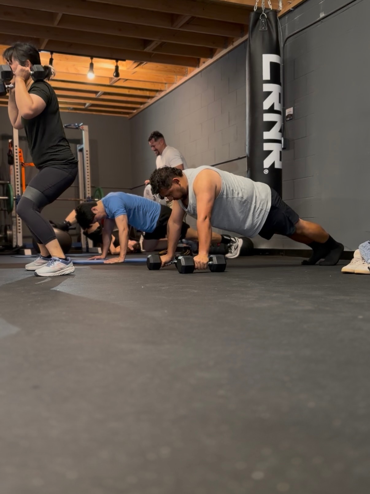 Strength and conditioning training at MMA District — squats, push-ups, and fight-paced conditioning